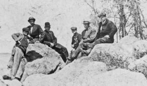 Men sitting on rocks  